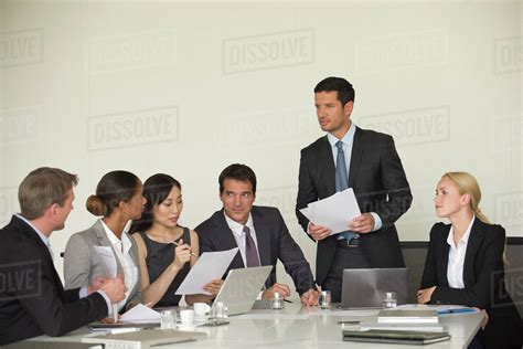 Executive giving presentation in meeting - Stock Photo - Dissolve