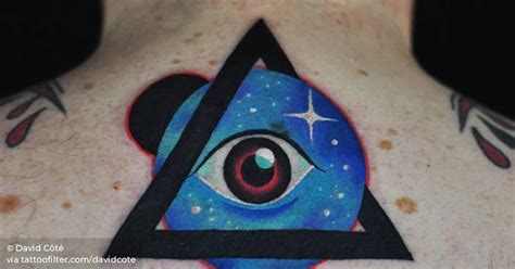 Psychedelic eye tattoo on the upper back.