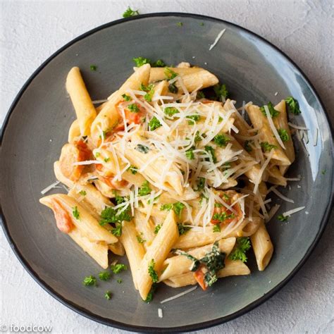 Penne pasta in Creamy Alfredo Sauce with tomatoes and Basil