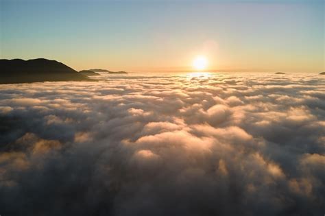 Premium Photo | Aerial view of colorful sunrise over white dense fog ...