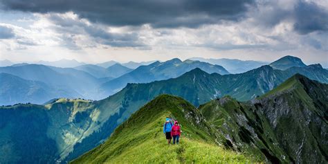 two people walking on mountain under gray sky during daytime free image | Peakpx