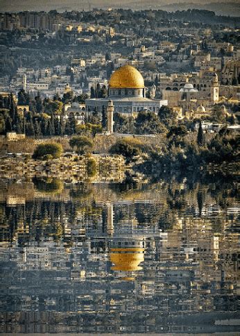 the dome of the rock is reflected in the water