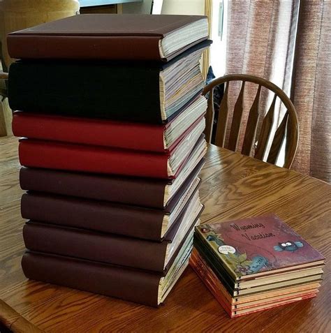 a stack of books sitting on top of a wooden table