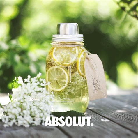 a jar filled with lemonade and some white flowers