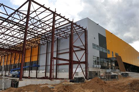 Construction of a warehouse building. Installation of metal structures. Stock Photo | Adobe Stock