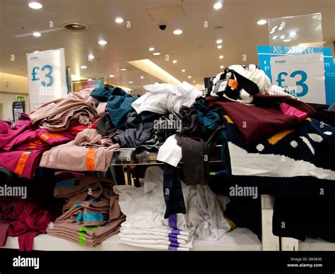 Shelves of cheap clothes for sale at Primark, Exeter, Devon, UK Stock Photo - Alamy