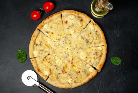 Premium Photo | Four cheese pizza with different types of cheese on a ...