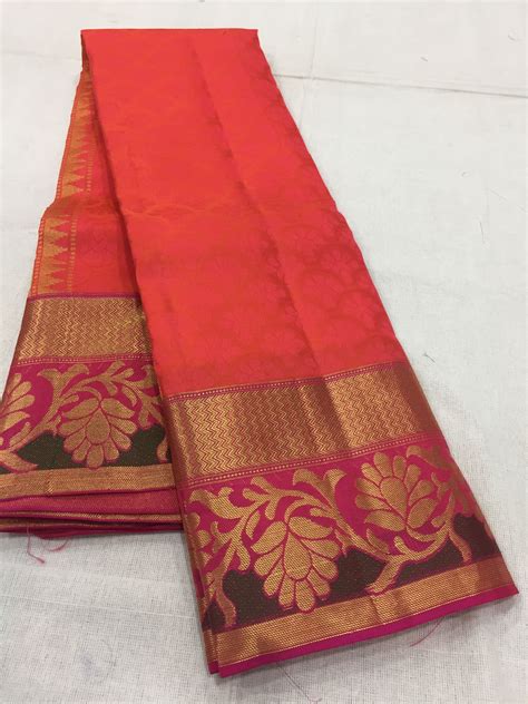 two red and gold banaram sarees laying on top of each other