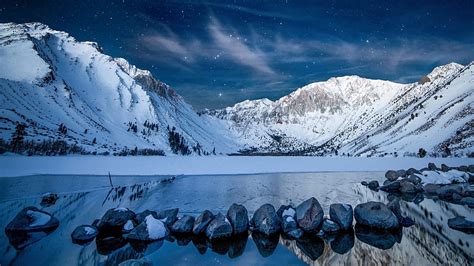 Beautiful Snowy Mountains In Starry Blue Sky Background During ...