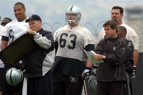 Oakland Raiders center Barret Robbins (63) stands beside coach Bill Callahan, right, during a w ...