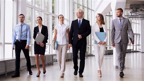 people, work and corporate concept - business team with folders walking along office building ...