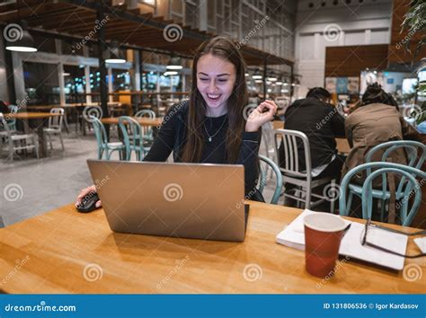 Young, Beautiful Girl Working with Laptop and Drinking Coffee at a ...