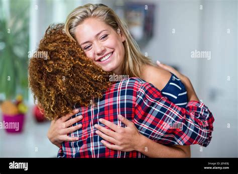 Happy friends hugging Stock Photo - Alamy