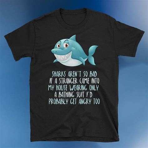 a black t - shirt with an image of a shark saying sharks aren't so bad