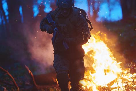 Soldier in Action at Night jumping over fire 11616873 Stock Photo at Vecteezy