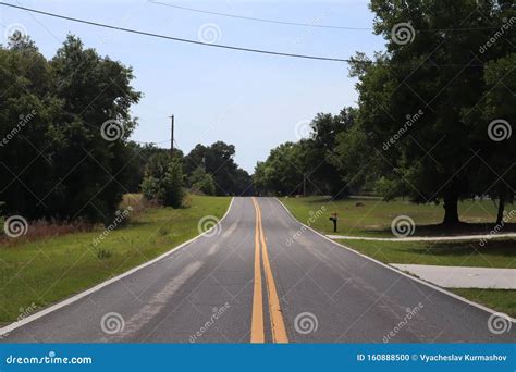 Two-way Road Divided by Two Yellow Solid Lines. Two Lane Road Stock Photo - Image of grass ...