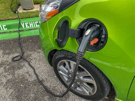 An Lime Green Electric Vehicle Charging at a Free Public Charging Station Editorial Photography ...