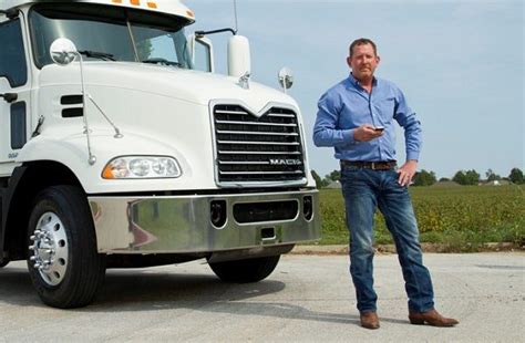 a man standing in front of a semi truck