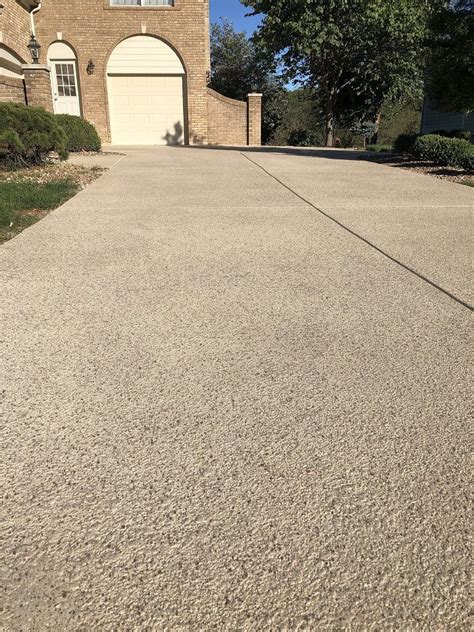 This beautifully resurfaced concrete driveway complements the overall ...