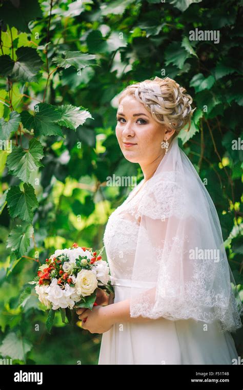 beautiful young bride stand on background forest Stock Photo - Alamy
