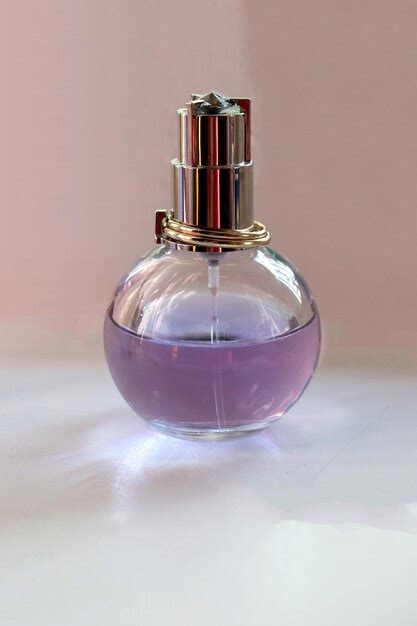 Premium Photo | Perfume bottle with purple liquid and a metal cap with ...