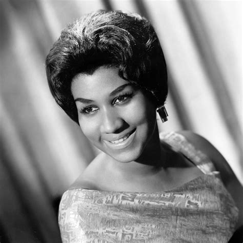 an old black and white photo of a woman with short hair smiling at the ...