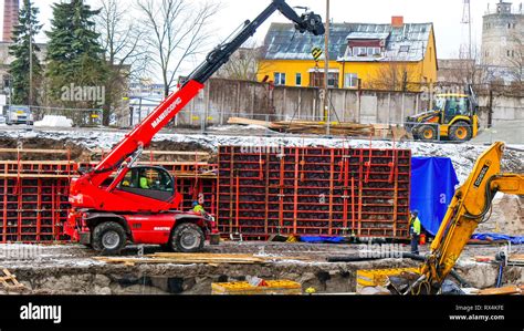 Red crane truck carrying a load of metals. The crane is carrying a red ...