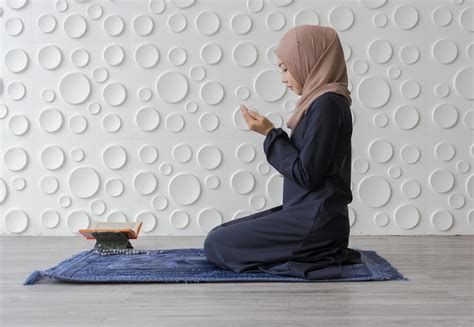 Muslim woman kneeling in prayer 1226747 Stock Photo at Vecteezy