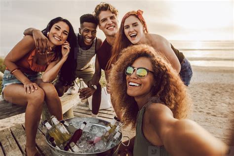 Woman talking selfie with friends at the beach party stock photo ...