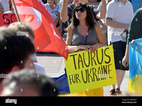 Munich, Germany. 18th Aug, 2023. Demonstrators hold placards before the ...