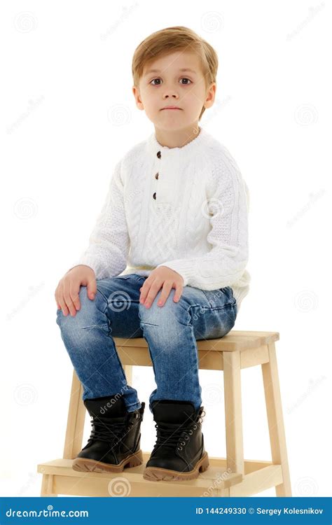 A Little Boy is Sitting on a Chair. Stock Photo - Image of seat, little: 144249330