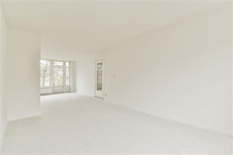 Premium Photo | An empty living room with white walls and a window