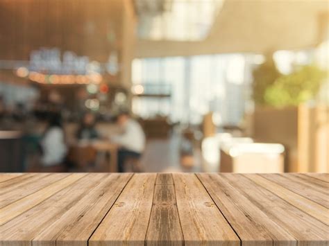 Wooden board empty table top on of blurred background. Photo | Free Download