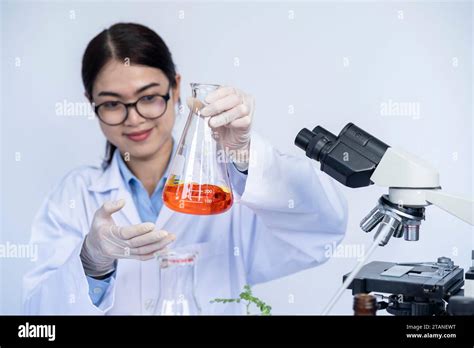 Laboratory researcher holding medical glass bottle with liquid ...