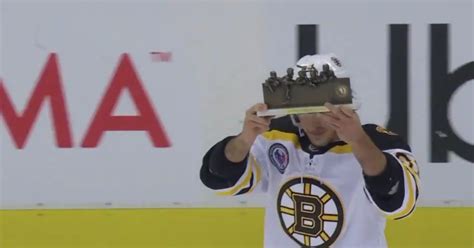 Brad Marchand celebrates his “Player of the Game” honor in front of an ...