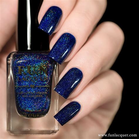 Here's a navy blue nail polish with an iridescent shimmer to paint your nails like a beautiful ...