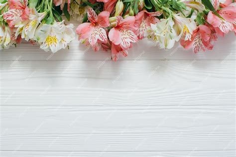 Premium Photo | Beautiful flowers on white wooden background