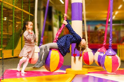 Child jumping on colorful playground trampoline. Kids jump in ...