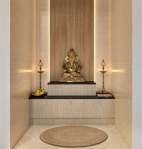 a golden buddha statue sitting on top of a wooden bench next to two candles and a rug