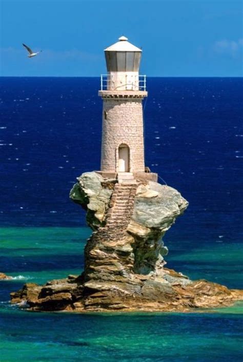 Rising up out of a weather-worn stone spire, the Tourlitis Lighthouse ...