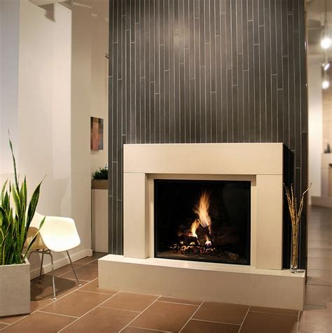 Fireplace featuring a wall of beautiful tiles. | Contemporary fireplace designs, Contemporary ...