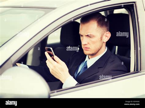 man using phone while driving the car Stock Photo - Alamy