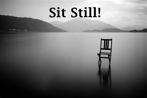 a black and white photo with a chair in the water that says, sit still