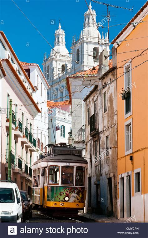 Electrico Tram 28 passing through a street in Alfama district Stock Photo, Royalty Free Image ...