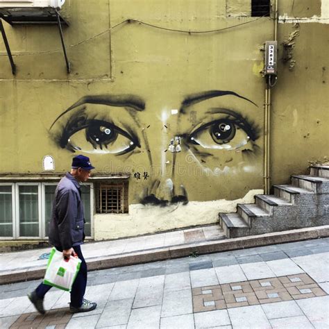 Sheung Wan, Hong Kong Street Art: Man Walking Past Mural Editorial ...