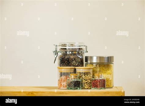 Glass jars of different sizes filled with spices, seasonings, soup ...