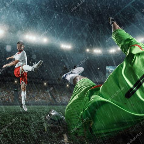 Soccer players performs an action play on a professional rainy stadium — Stock Photo ...