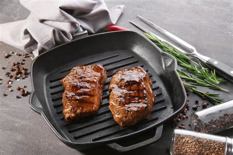 Premium Photo | Grill pan with tasty steaks on table