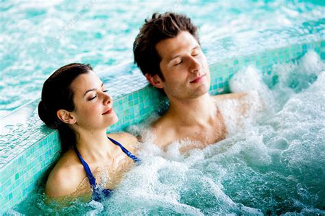 Couple in spa pool - Stock Image - C031/3672 - Science Photo Library