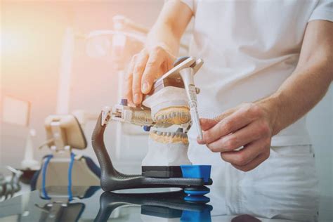 Dental Technician Working with Articulator in Dental Lab Stock Photo ...